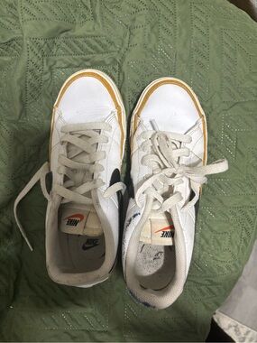 Nike White Leather Sneakers with Black Swoosh and Yellow Accent